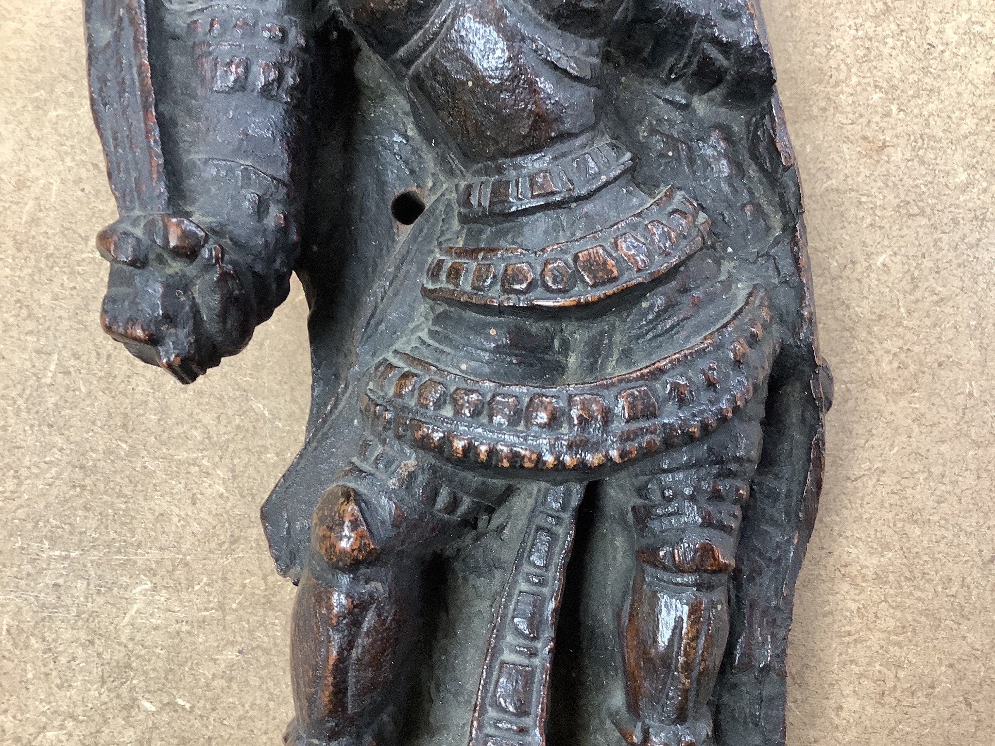An Indian hardwood figural relief, 18th century or earlier, 28cm, a dagger and two carving knife sets